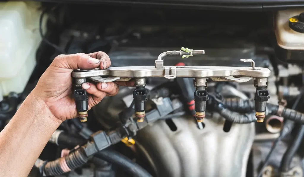 mechanic inspecting fuel injectors