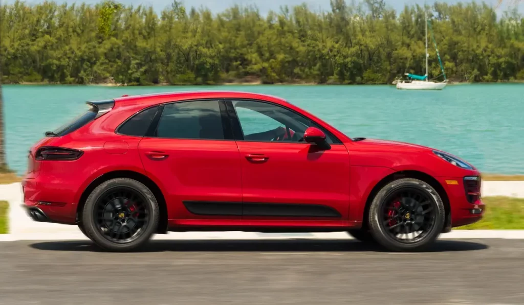 red porsche macan with sea background