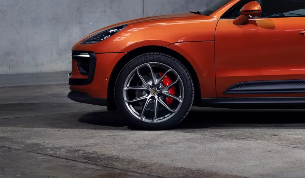 orange porsche macan S warehouse background